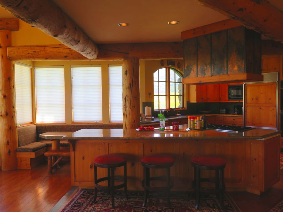 The kitchen has a bar and side table for close eating.  