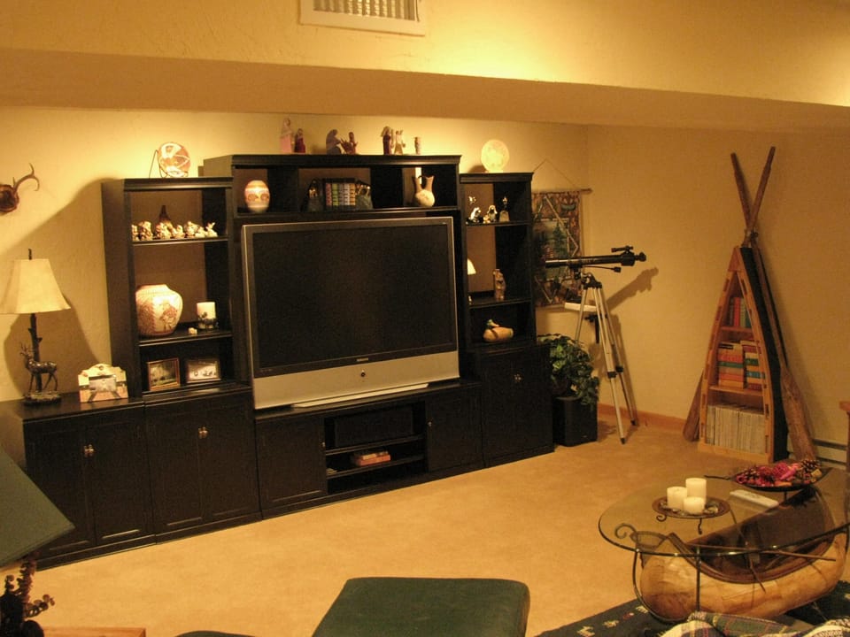 Downstairs den and TV room with big screen and game tables