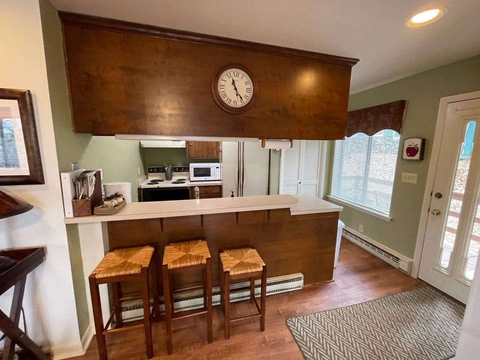 Kitchen with plenty of amenities, like pots, pans, & utensils.