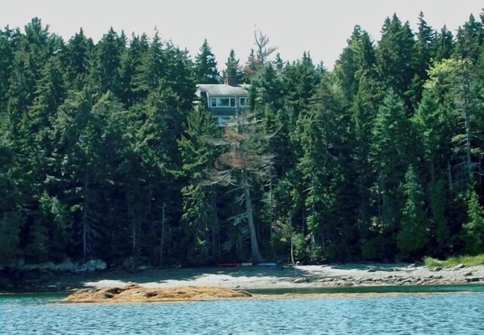 Cottage is situated above the water. A small beach is reached via a steep path
