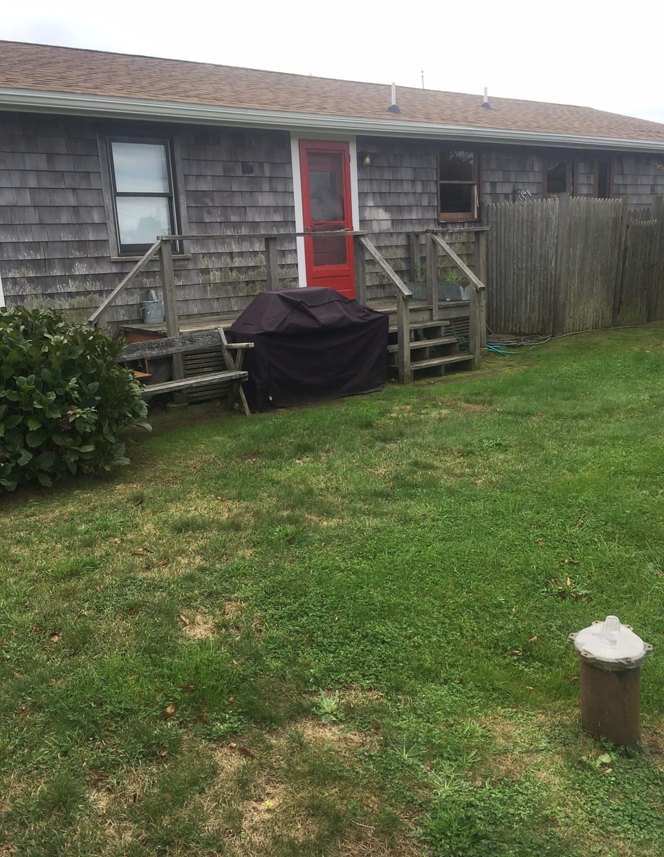 Outdoor shower and Weber grill on the back side of the house.  