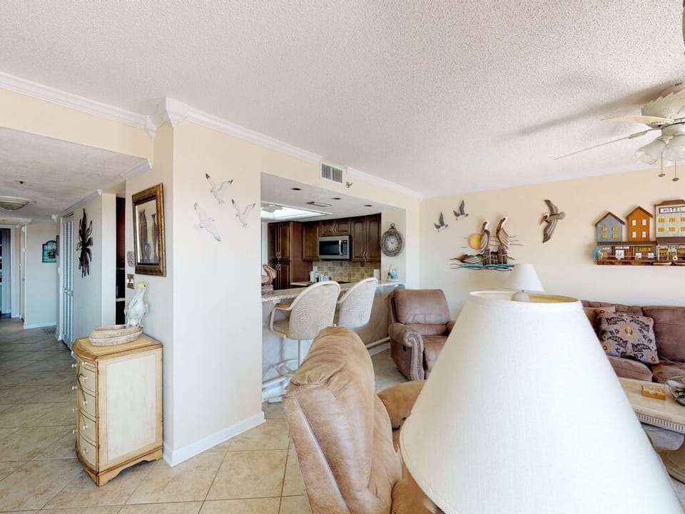 living room & bar stools at kitchen
