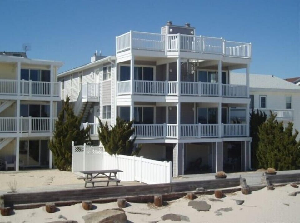 View of home from the beach. Elevated mid level is the living unit.