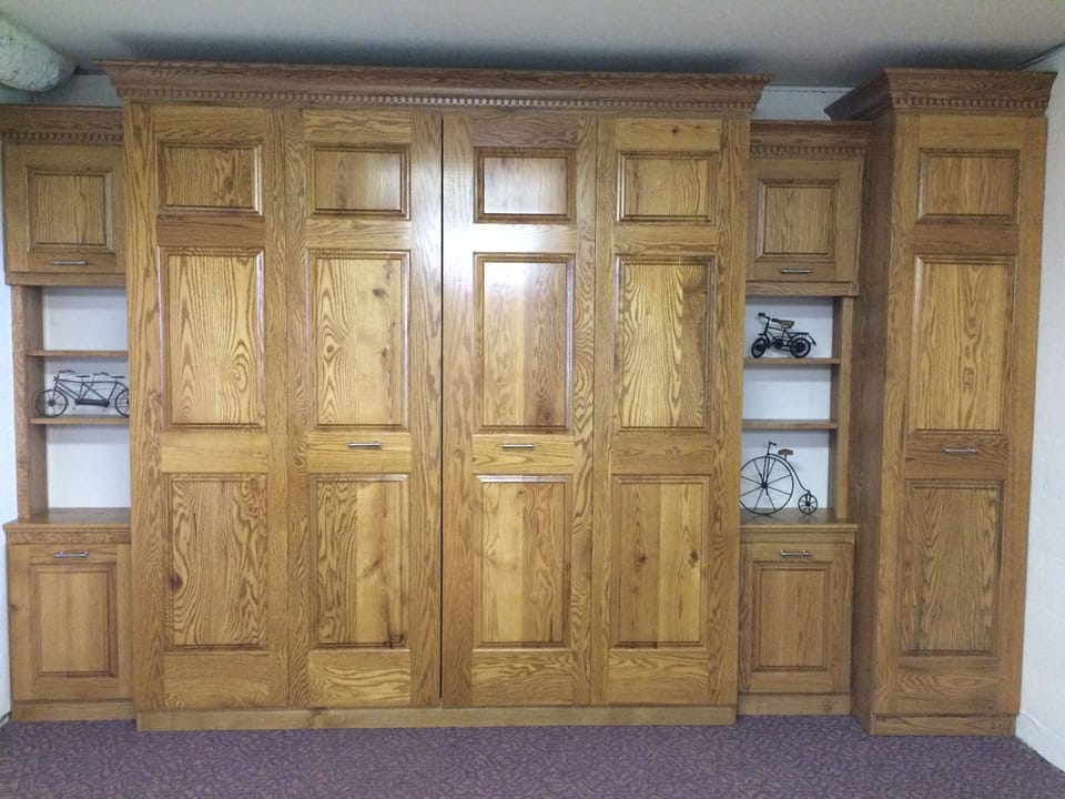 Closed King Murphy bed in basement.  This leaves  room for the ping pong table