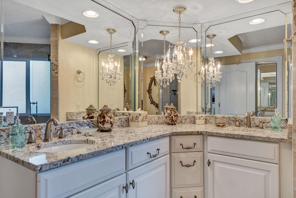 Master bathroom with custom cabinets, granite countertops and crystal chandelier