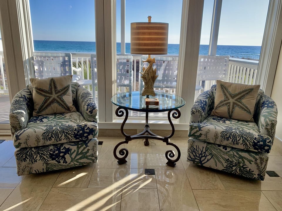 Sea-themed swivel chairs showing ocean in background (replaced the beige chairs)