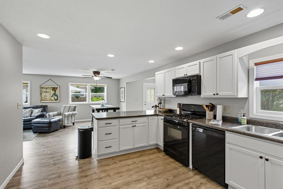 Updated kitchen with peninsula and barstools