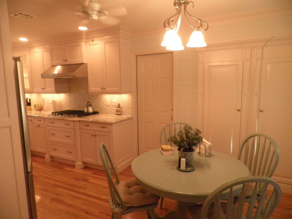 Eat-in kitchen and door to garage and built-in pantries. 