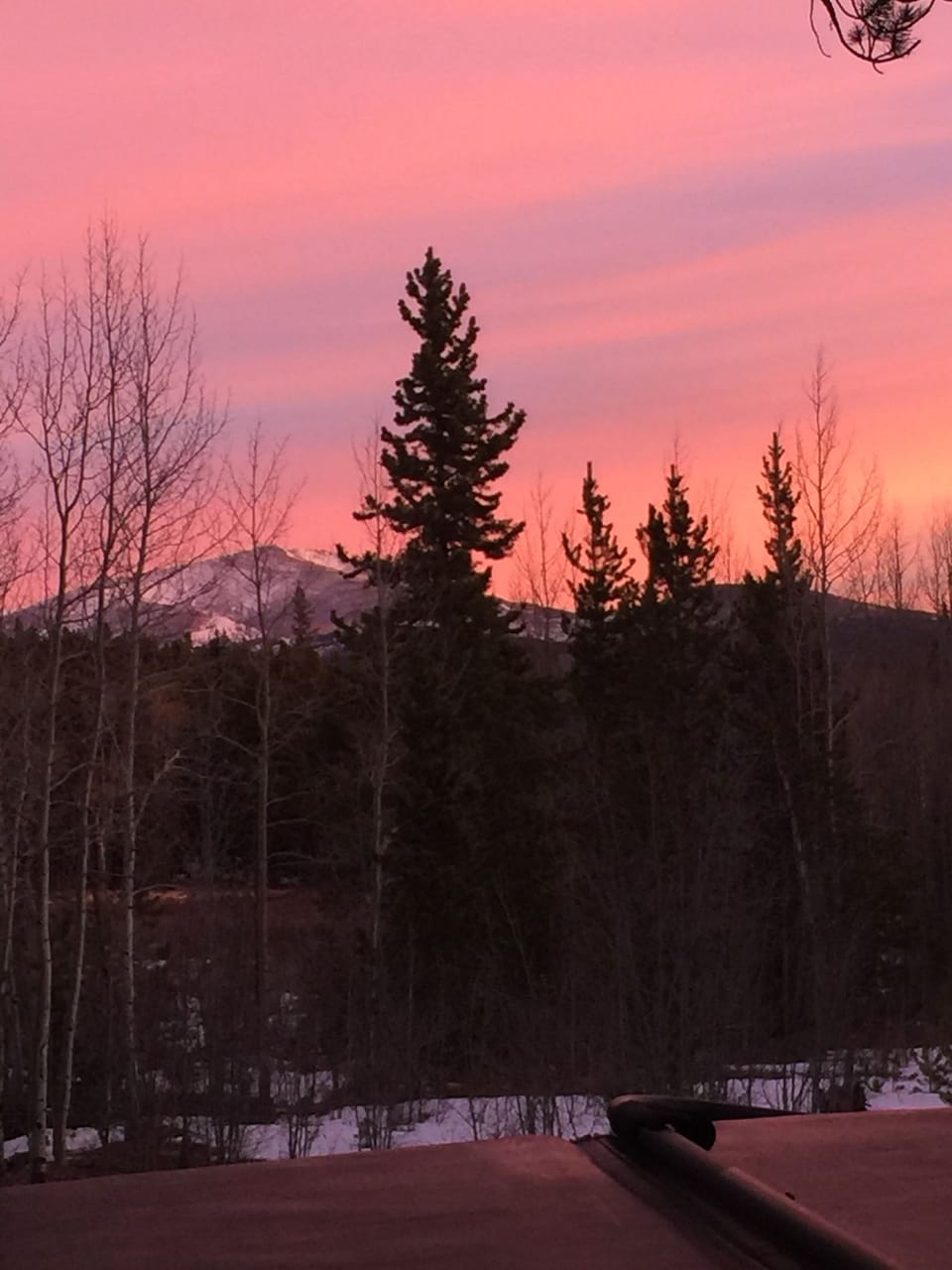 Sunset view from hot tub of secluded cabin.