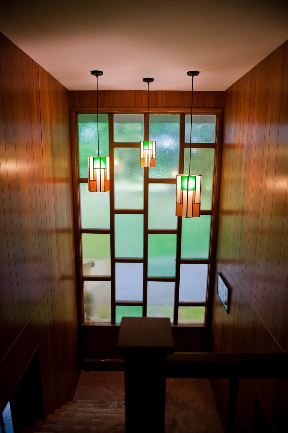 Stairwell down to first floor in main house.