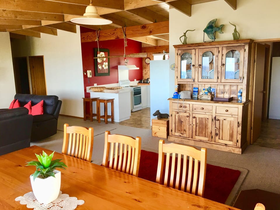 Open plan dining, lounge and kitchen with seaviews
