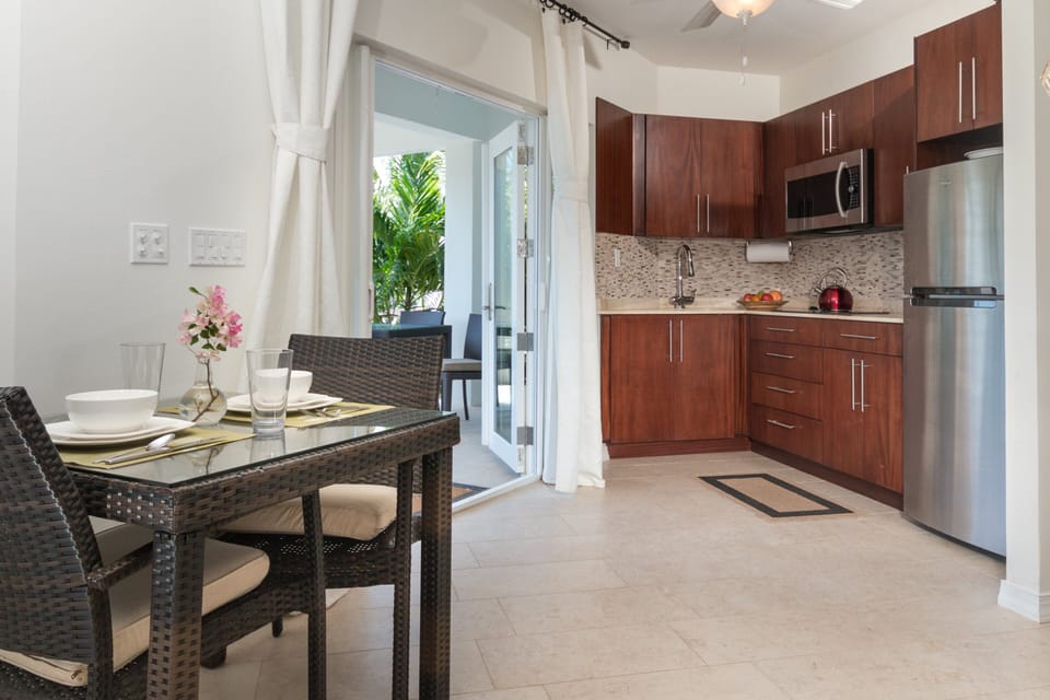 Discover a functional kitchenette seamlessly integrated with a comfortable eating area, offering convenience and style in a compact space