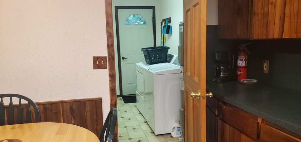 Laundry room in room next to kitchen