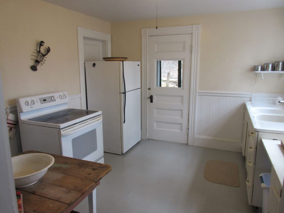 Kitchen with door going to laundry area