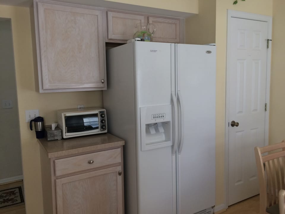 Large side by side frig with ice and cold filtered water on door