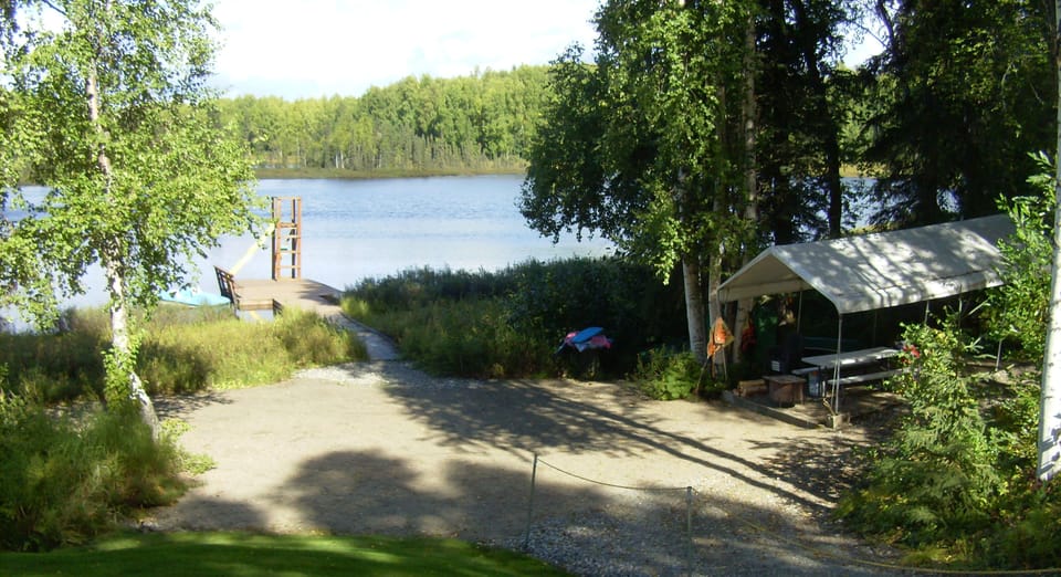 Beach area with picnic table and firepit.