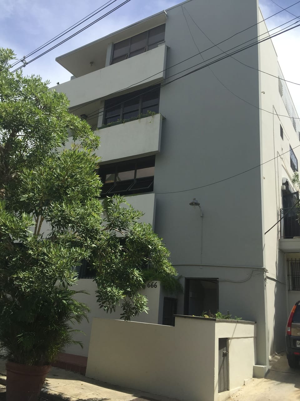 Building front and main entrance.  Waste disposal at the right side.