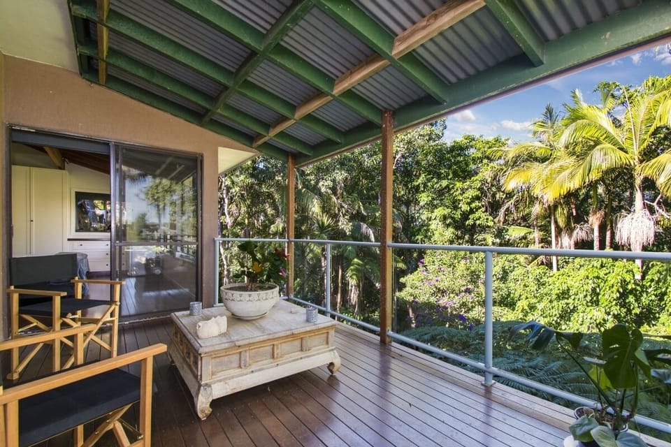 Deck area overlooking treetops and adjoining master king bedroom and living