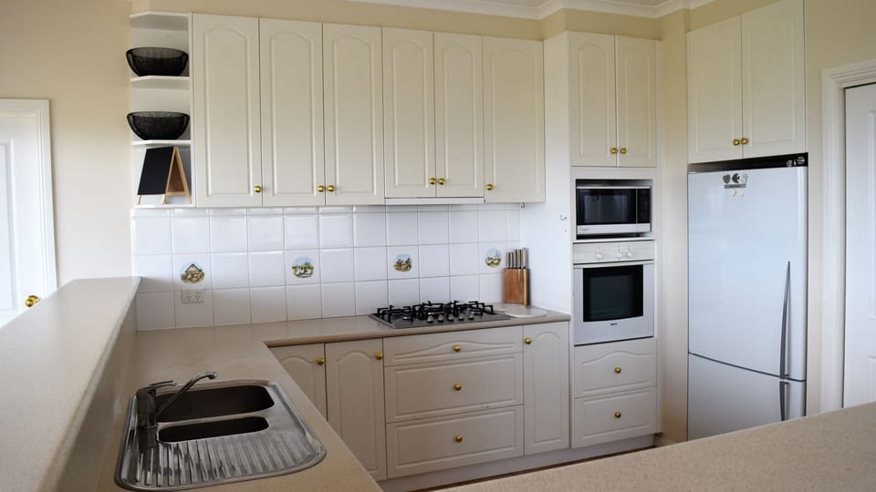 Kitchen has dishwasher, oven, microwave, large fridge, spices, cookbooks  + more