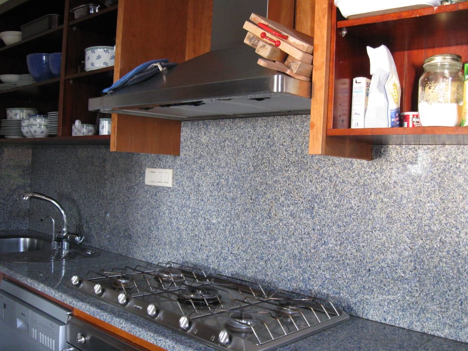 Kitchen with five burner gas stove, electric oven, dishwasher, granite counters