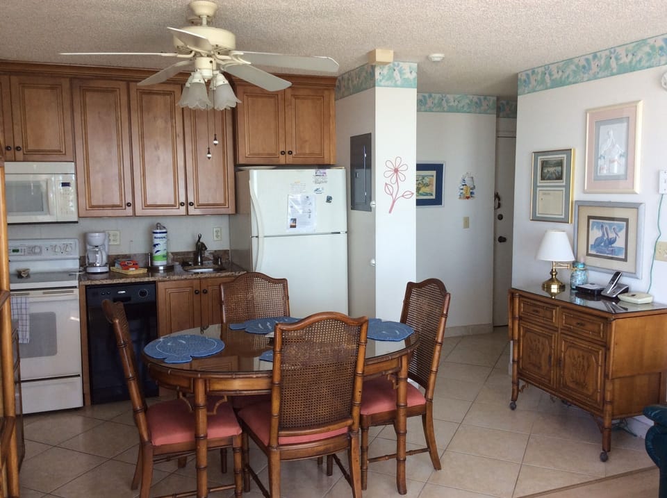 Entry, remodeled kitchen with dishwasher and dining area