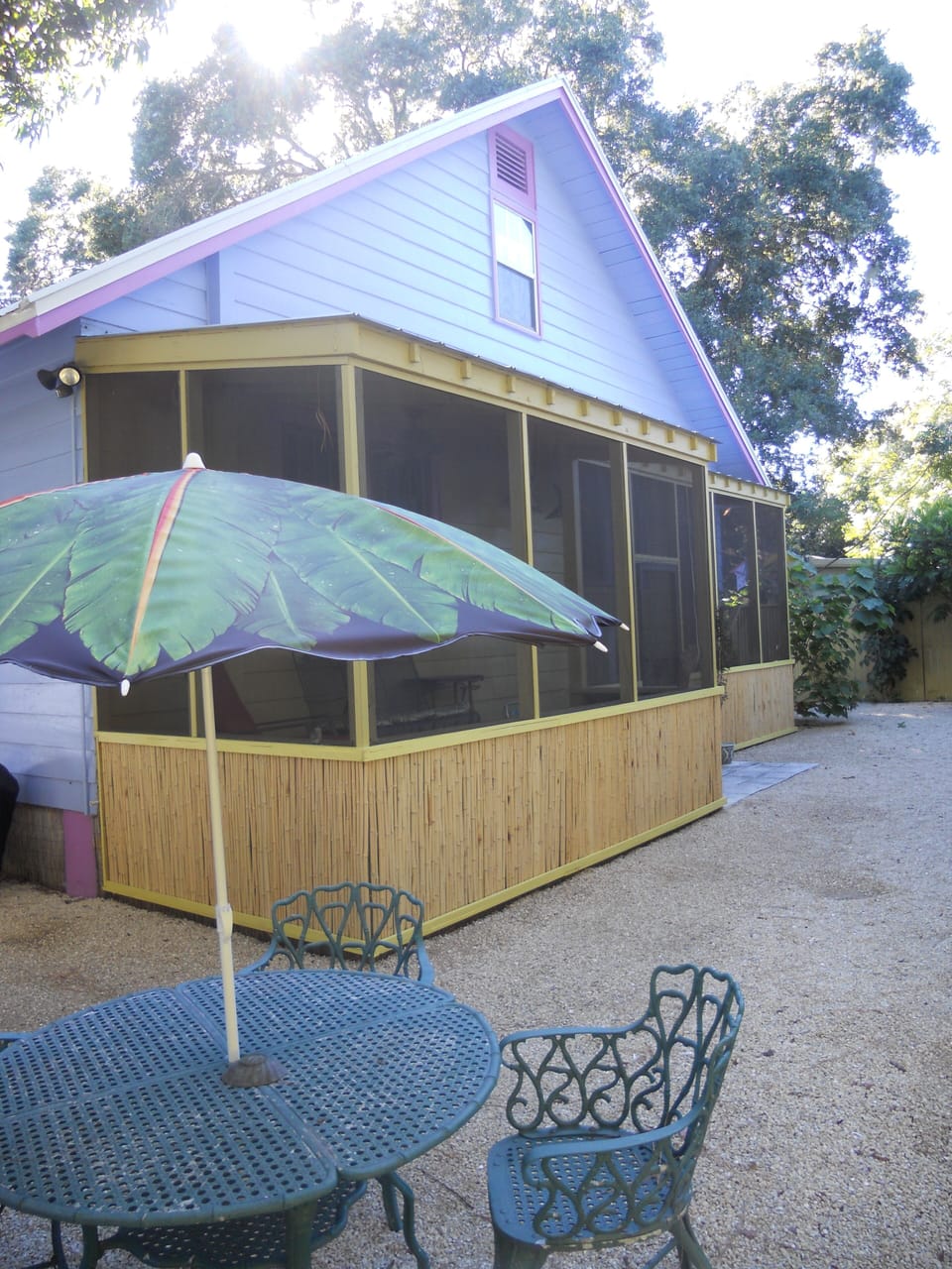 fenced back yard with charcoal grill.