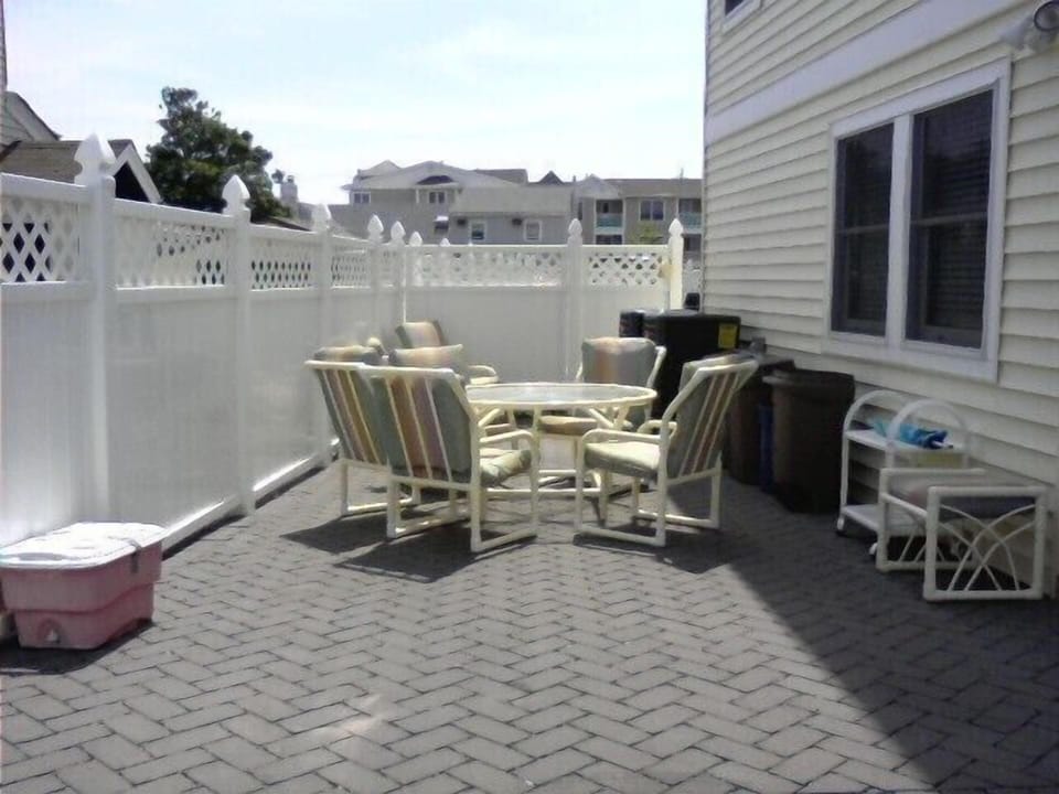 Private Patio area with cushioned chairs, table & grill