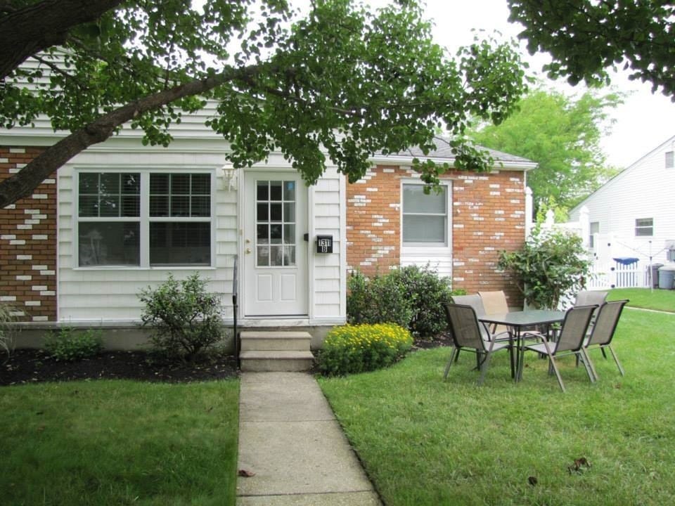Yard with patio furniture, Weber gas grill, outside enclosed shower