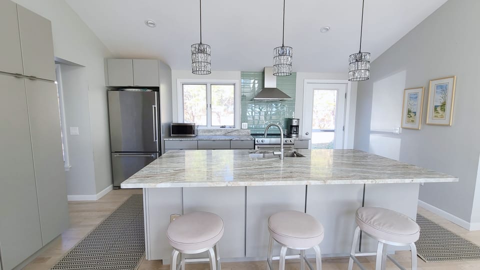 Nicely equipped kitchen with granite countertops and counter seating