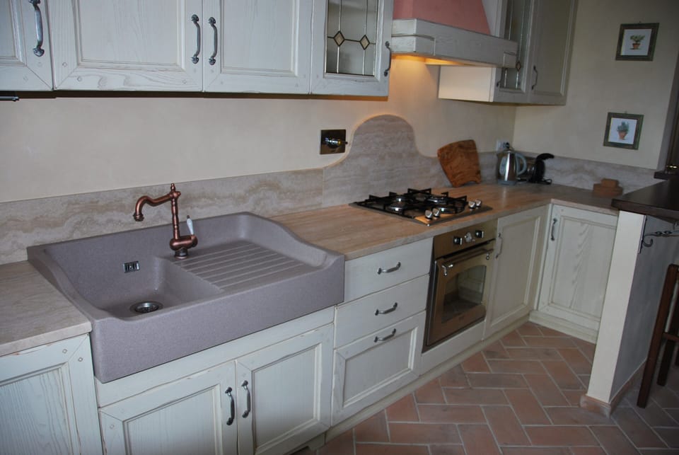 Modern kitchen with new appliances -travertine bench top