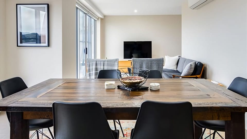 The perfect balance of comfort and sophistication in this well-appointed apartment, where a spacious dining table complements the inviting lounge area.