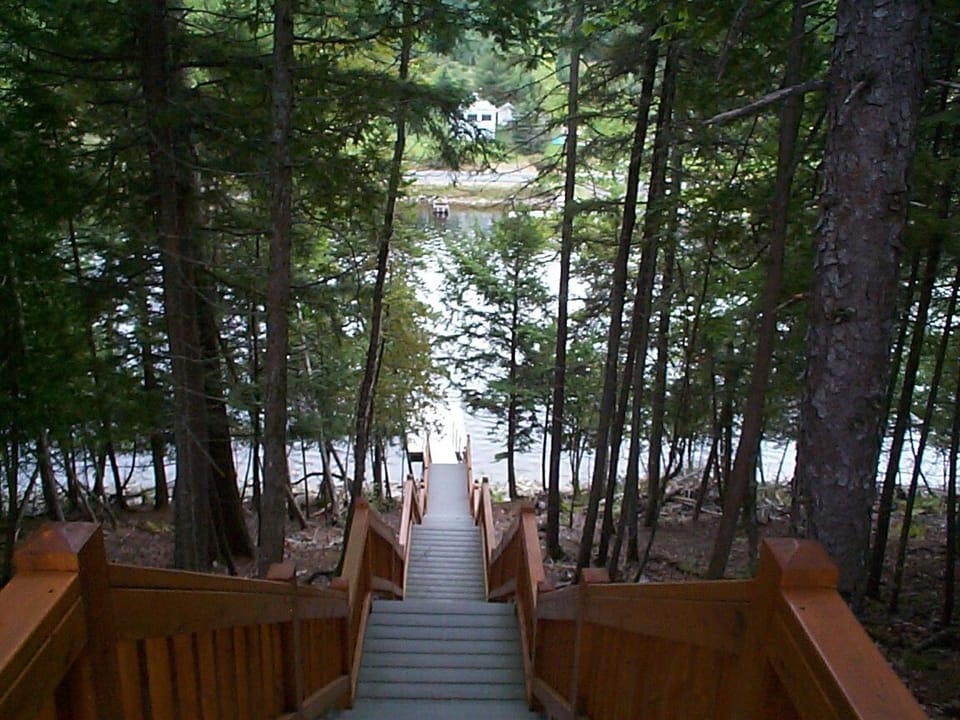 Steps leading down to private dock on Moose River leading to Moosehead Lake
