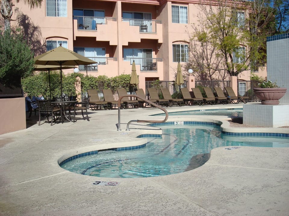 Relaxing jetted spa, top quality chaise lounges, tables and chairs on sun deck