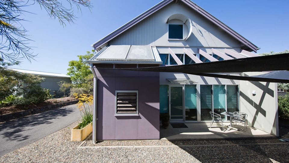 Front view of studio with guest car space under shade sails