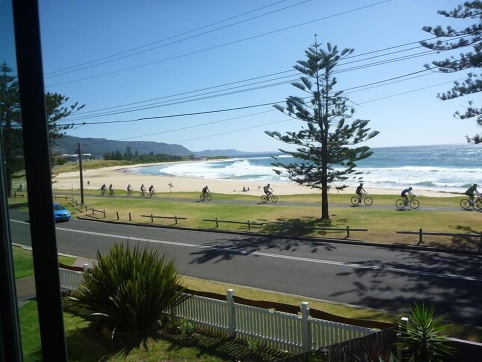 Looking north to Sandon Point from balcony ,bike track,patrolled beach in summer