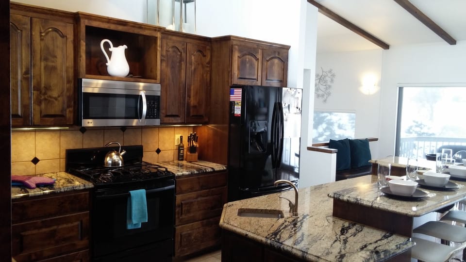 Granite island, two stoves and breakfast bar make for a perfect brunch spot 