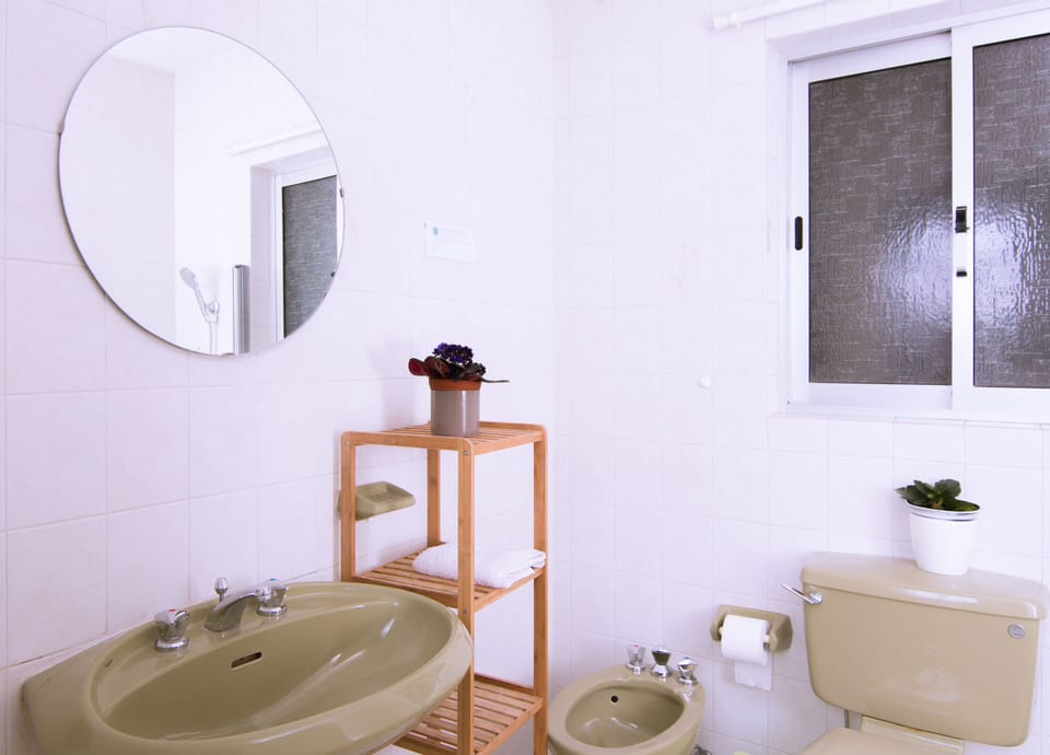 bathroom equipped with bath and hanging shower