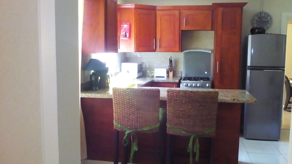 Kitchen with stainless steel appliances and breakfast bar