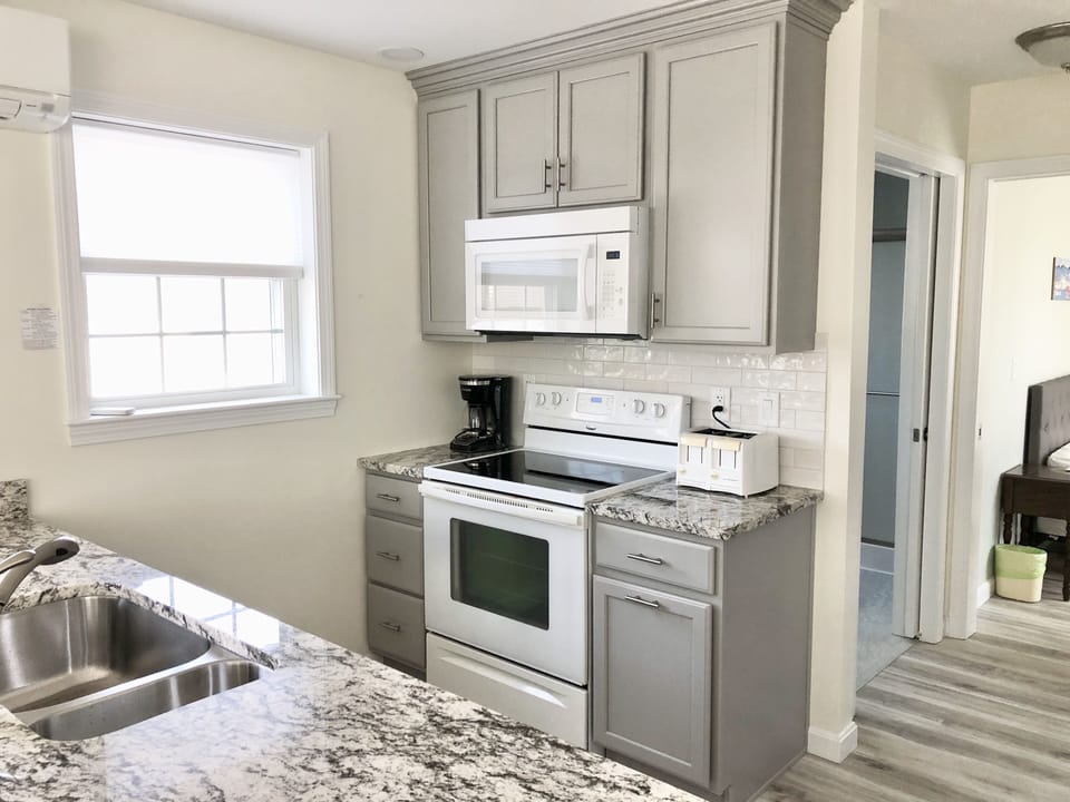Kitchen has lots of natural light. Bright and comfortable work area.