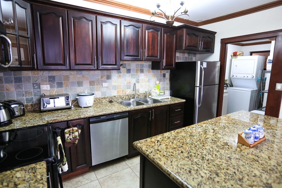 Washer/dryer unit and storage room next to the kitchen