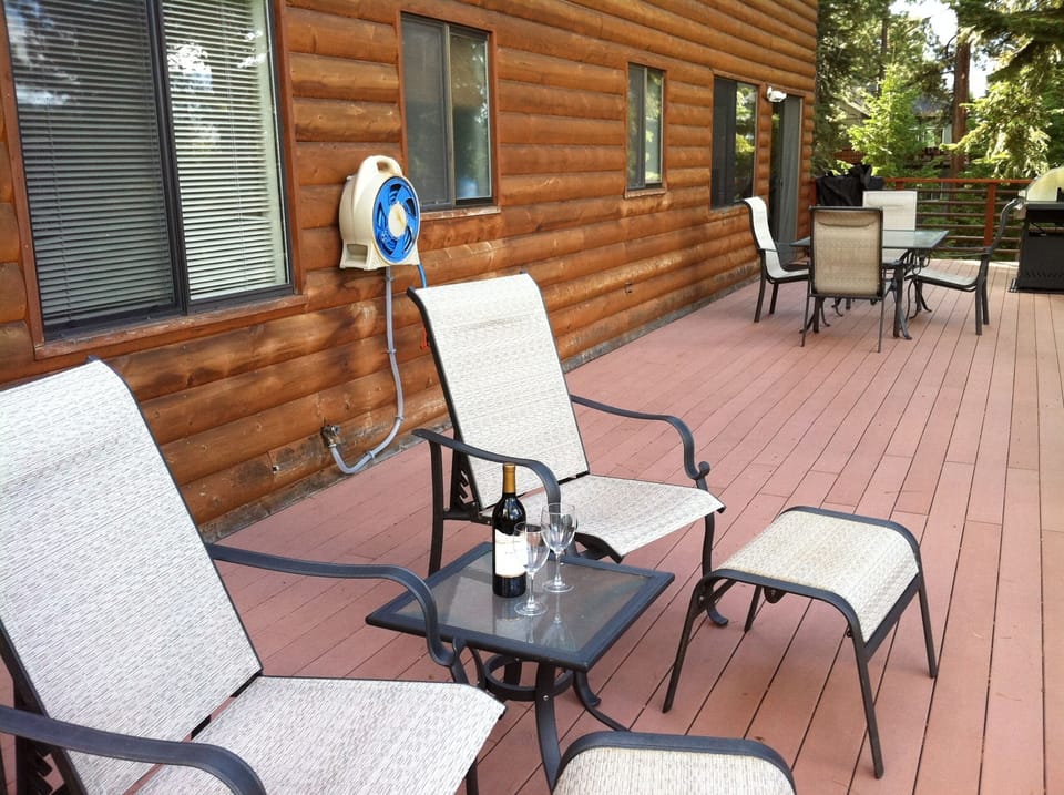 View of the large upper deck with table and chairs for dining outdoors.