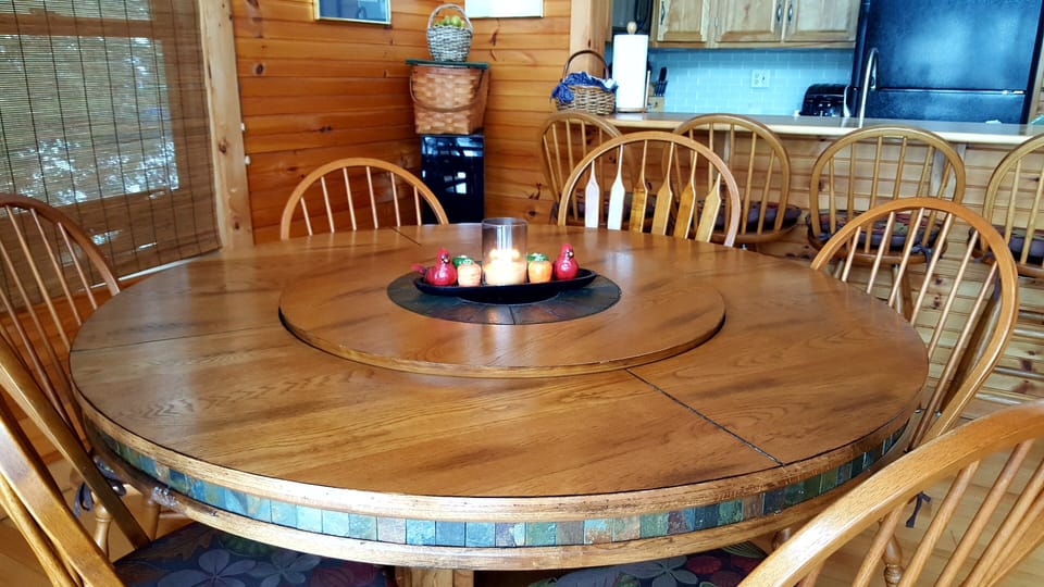 Large slate and hardwood dining table can accommodate 8 .