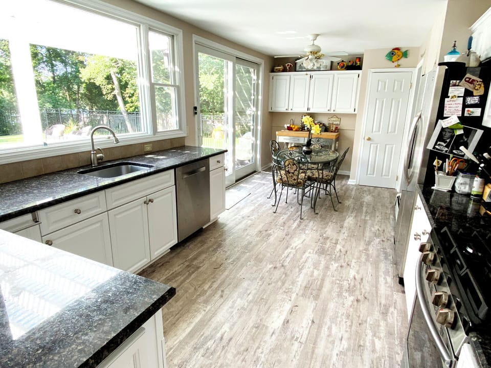 The kitchen is all glass with a spectacular view of the pool and creek