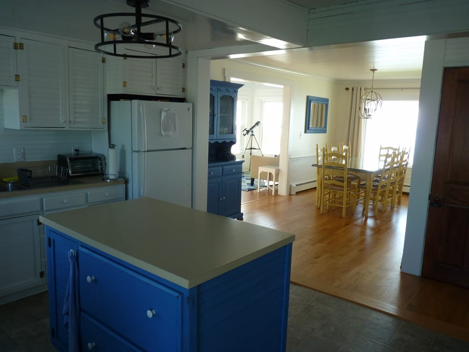 From kitchen looking into dining room and sun room and the ocean.