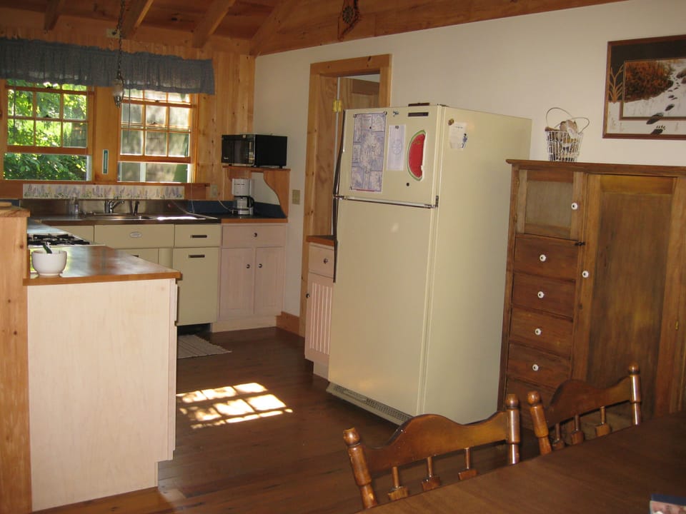 Kitchen with gas stove, microwave, toaster, coffee maker, refrigerator