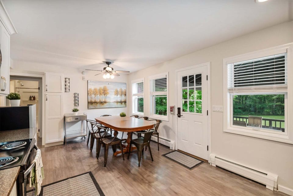 The round table catches natural light and sits an easy step from both the kitchen and deck.