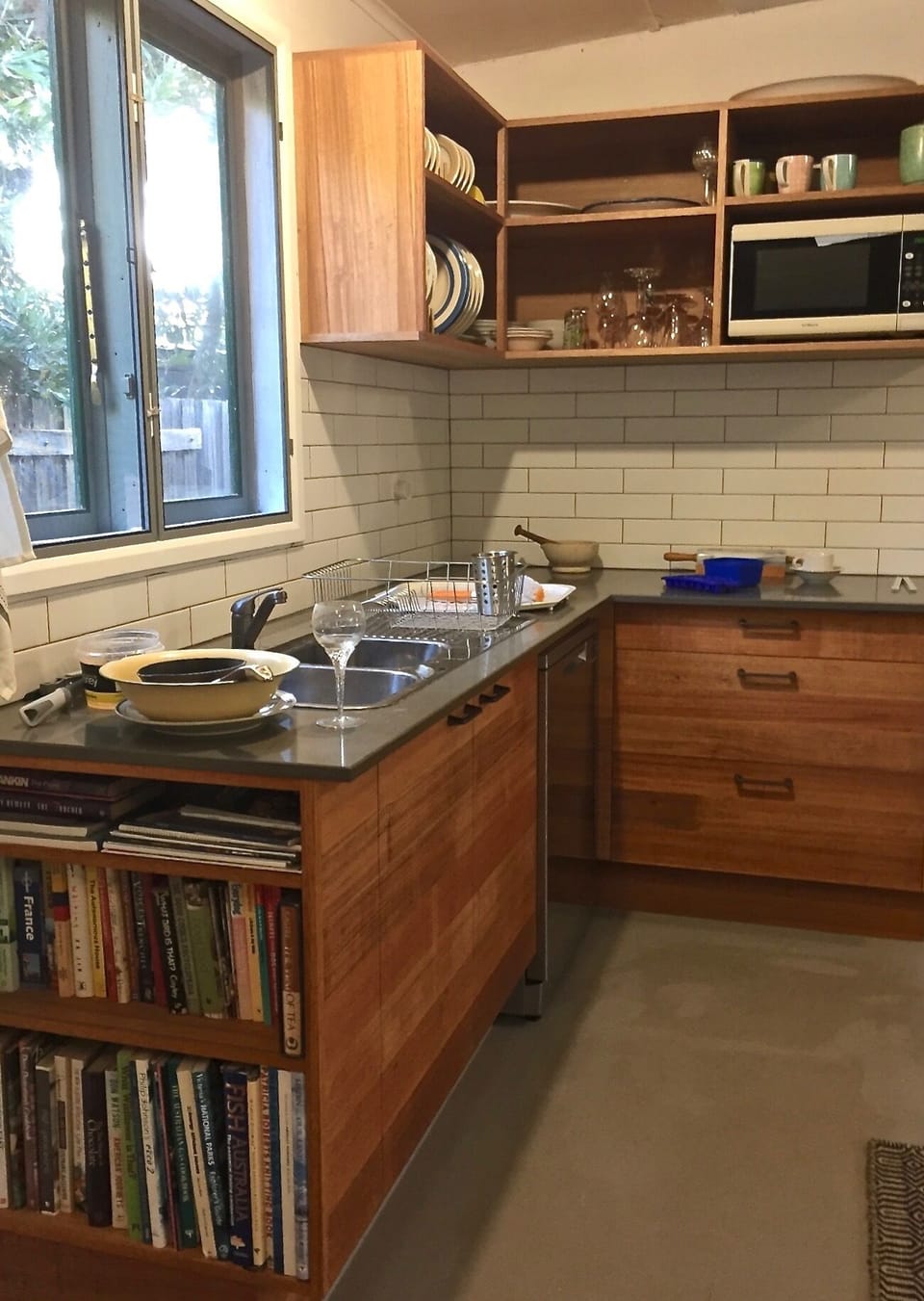 Sink, dish washer, microwave and end bookstore