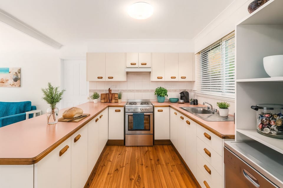 Kitchen with coffee pod machine, toaster,kettle, stove, blender.