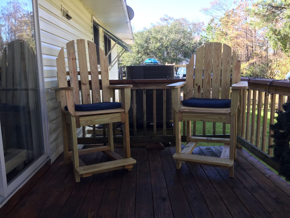 High chair on lighted deck off sliding door w mini shelf for drink/ snacks , 