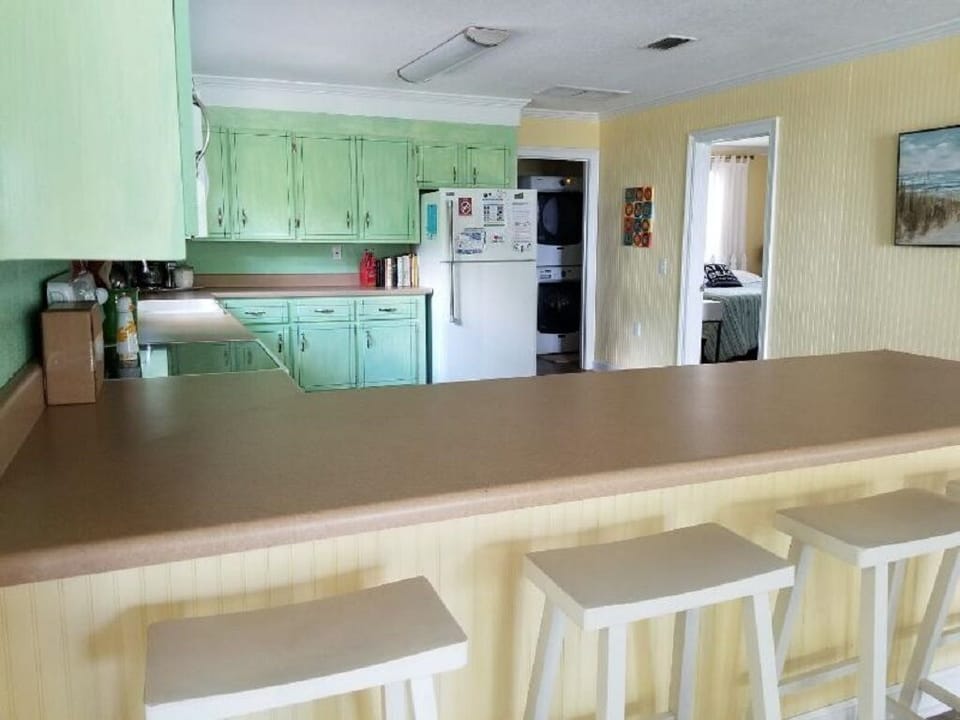 Huge kitchen is well equipped and has plenty of space for the family to cook.